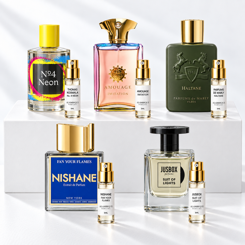 Discovery set Alambique: THOMAS KOSMALA No. 4 NEON, AMOUAGE IMITATION, PARFUMS DE MARLY HALTANE, NISHANE FAN YOUR FLAMES, JUSBOX SUIT OF LIGHTS. Decants con etiquetas blancas y atomizadores dorados junto a las botellas de referencia.