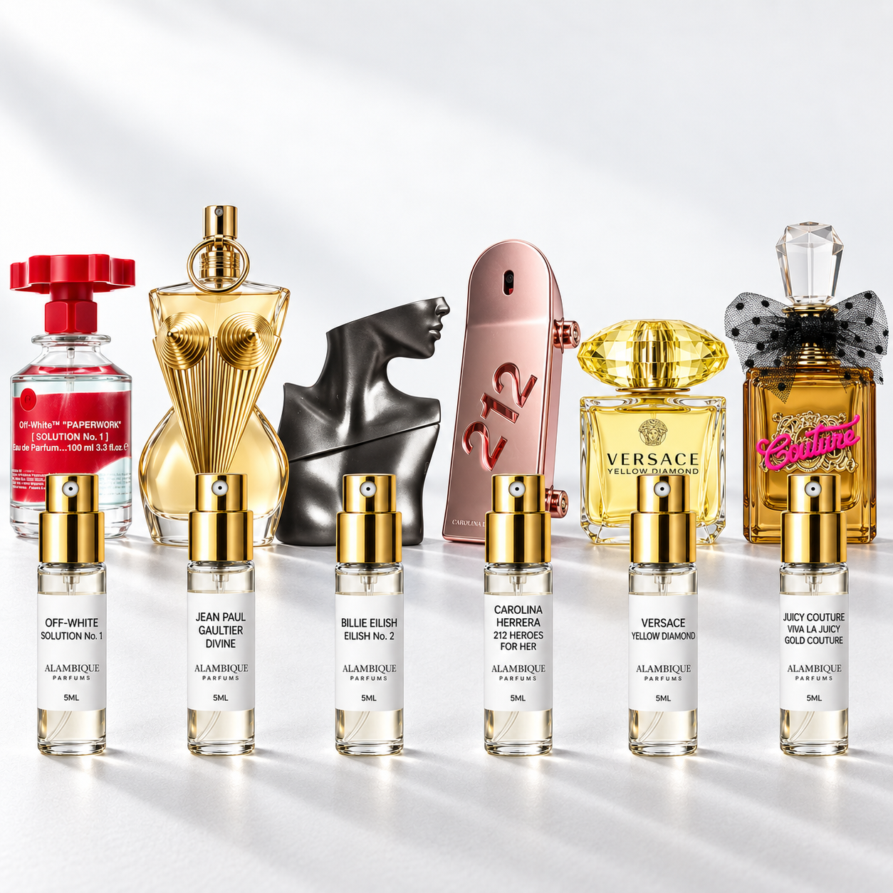 Date Night Mujer: seis decants de Alambique con sus perfumes de referencia al fondo. Botellas completas no incluidas.