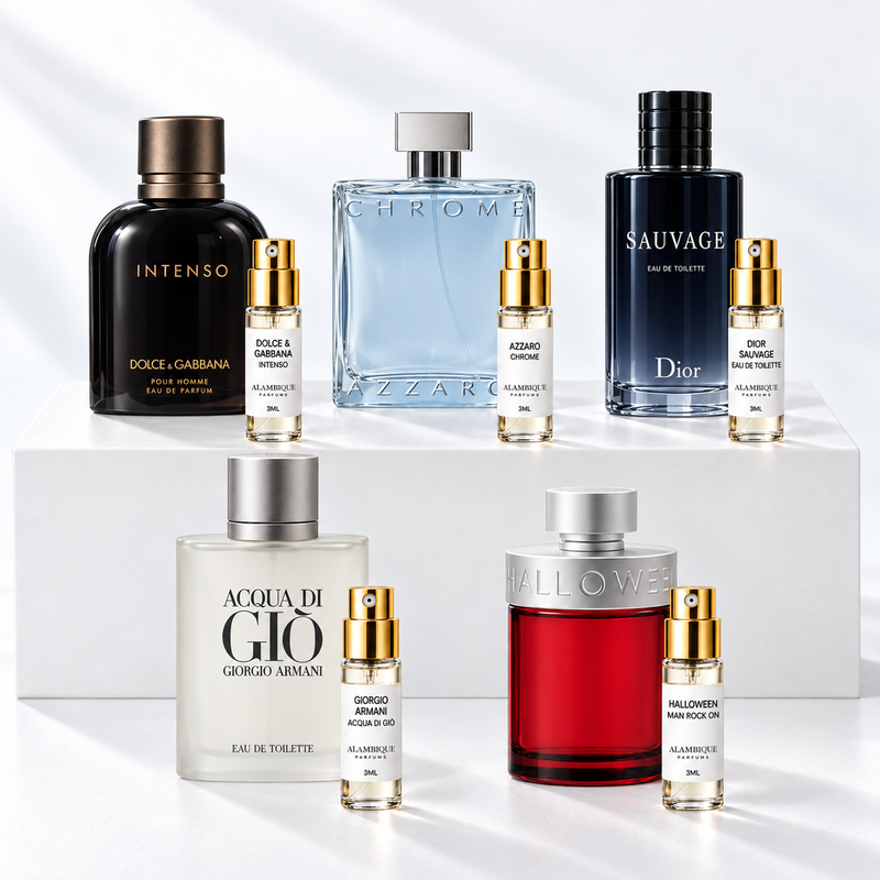 Discovery set Alambique: DOLCE & GABBANA INTENSO, AZZARO CHROME, DIOR SAUVAGE EAU DE TOILETTE, GIORGIO ARMANI ACQUA DI GIÒ, HALLOWEEN MAN ROCK ON. Decants con etiquetas blancas y atomizadores dorados junto a las botellas de referencia.