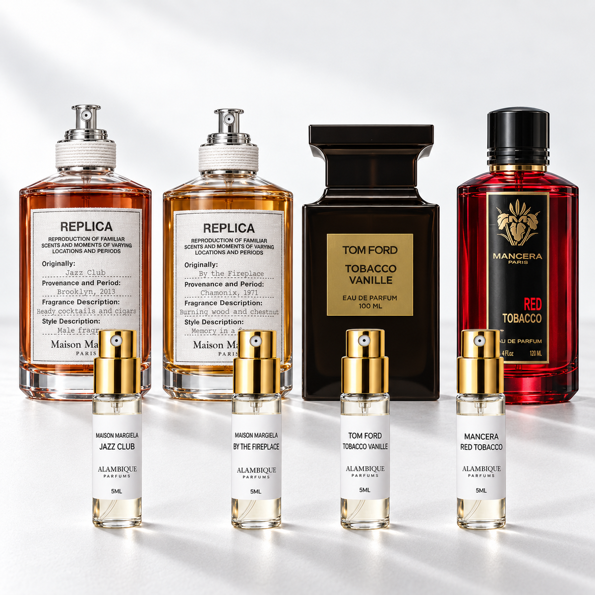 Noches de Frío Discovery Set: cuatro decants de etiqueta blanca frente a las botellas de referencia; las botellas originales no están incluidas.